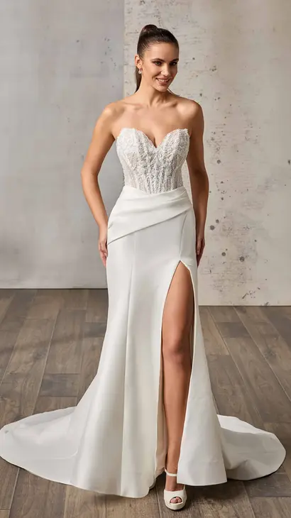 Eddy K mikado fit-n-flare wedding dress with a sweetheart neckline and a strapless body on a bridal model standing in a bridal studio