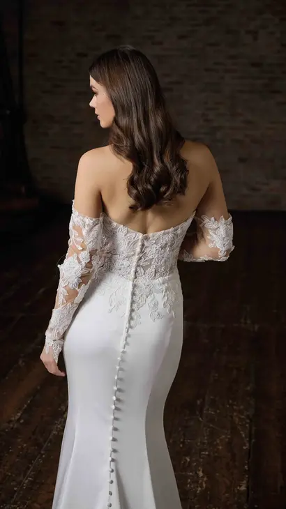 Close-up back of Eddy K fit-n-flare wedding dress with a straight neckline and a strapless body on a bridal model posing in a studio.