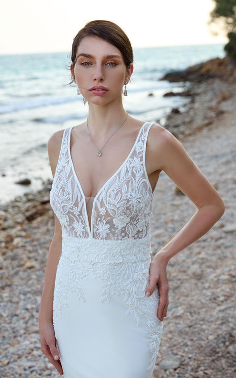 Eddy K wedding gown with lace bodice and mikado skirt with a v-neck on fair skinned woman with bun.