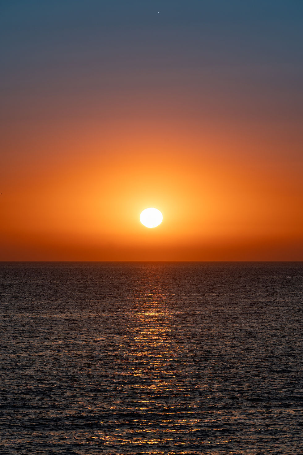 Sunset over the sea in San Antonio Ibiza with golden light on the water