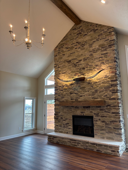 texas longhorns, longhorns fireplace, stone fireplace, great room chandelier