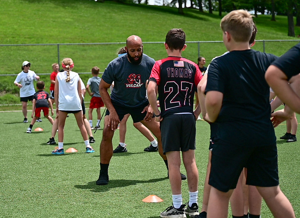 Coach Chandler Daniels of California University working with youth athletes to master the technique of changing directions, agility.
