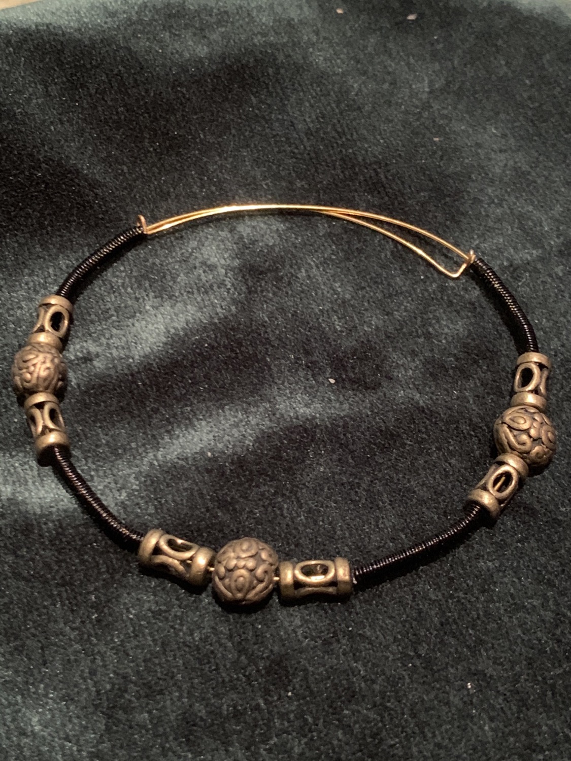 Black wire coil and brass beads