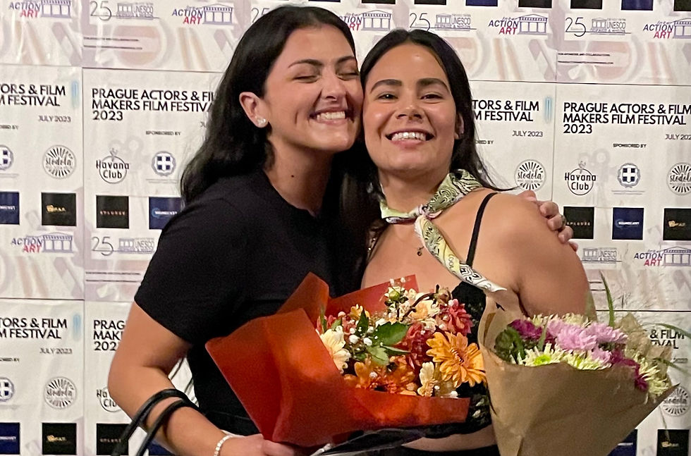 Two smiling girls with flowers in their hands