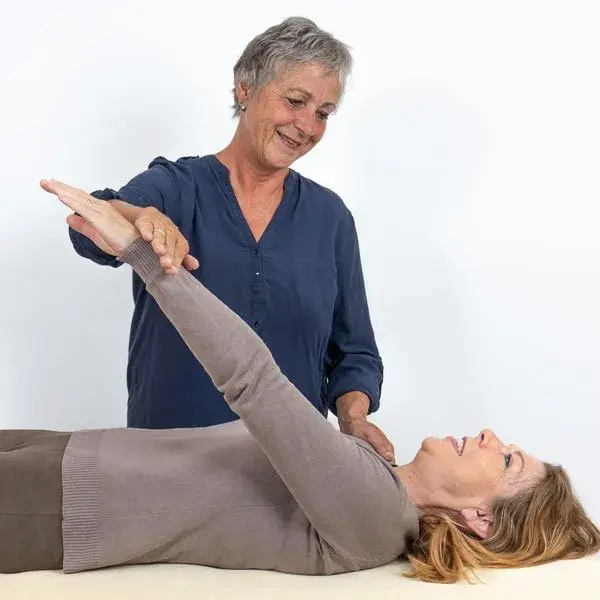Kinesiologist doing muscle testing on a client