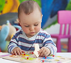toddler-playing-with-peg-puzzle.jpg