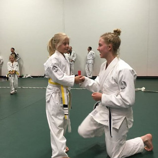 cora-on-the-mats-teaching.jpeg