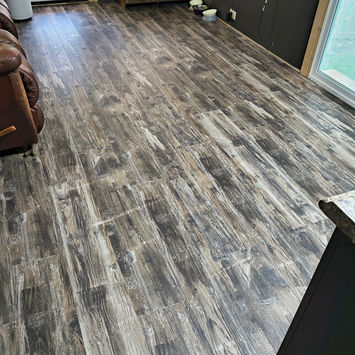 Rustic vinyl plank flooring with a distressed wood look installed by 490 Construction in an East Texas home