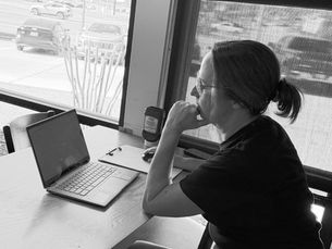 Local business owner working on marketing at a laptop in East Texas