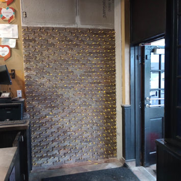 Tile feature wall installation in progress inside a commercial space in Longview