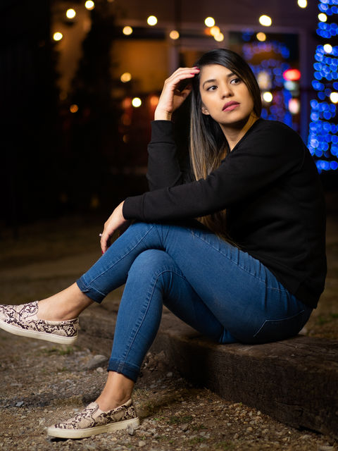 Beautiful lifestyle portrait of young Hispanic woman modeling in the city