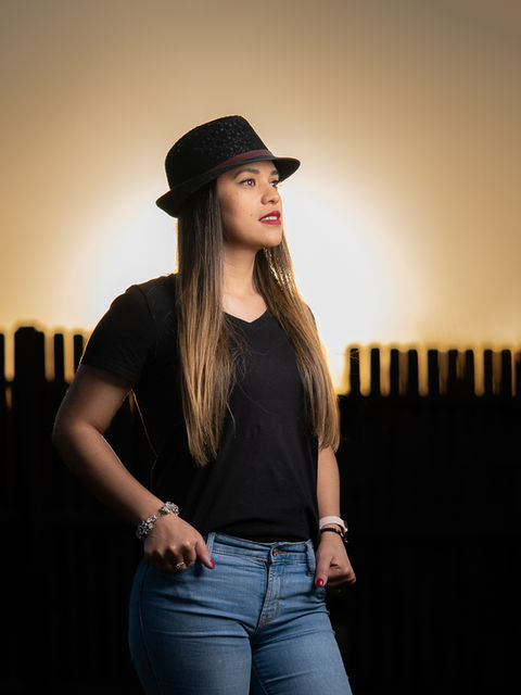 Beautiful lifestyle portrait of young Hispanic woman modeling in a park
