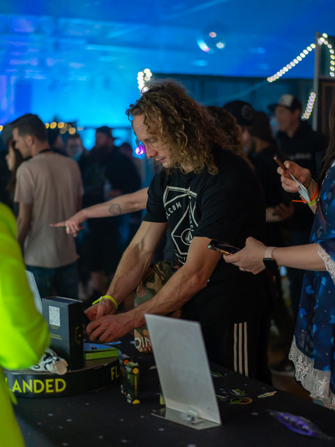 Professional event photography of young man at a trade show booth