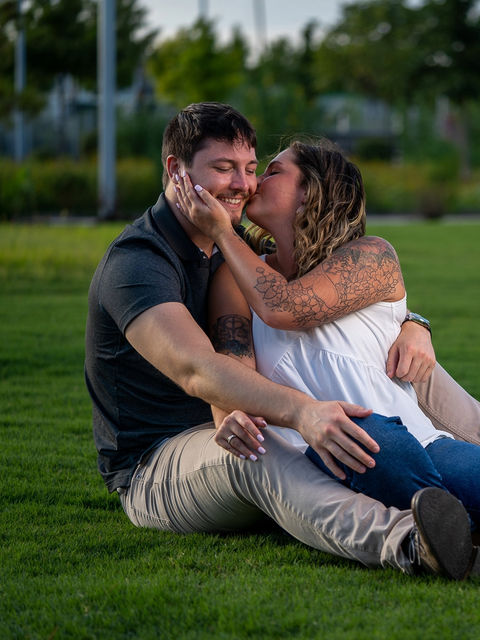 Beautiful portrait of a young couple getting engaged during a photo shoot at a park