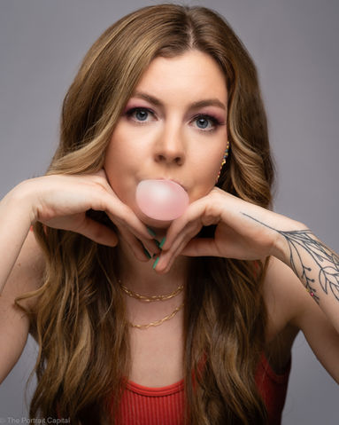 portrait of young woman with bubble gum for a birthday shoot