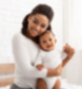 African American Mother Posing With Her Baby Boy At Home