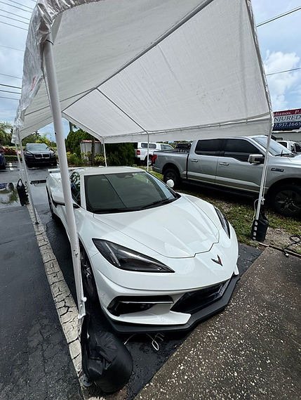 2025 Corvette, White, under a tent ready to be washed and detail