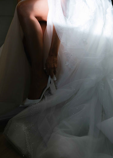 Image of bride putting on her shoes.
