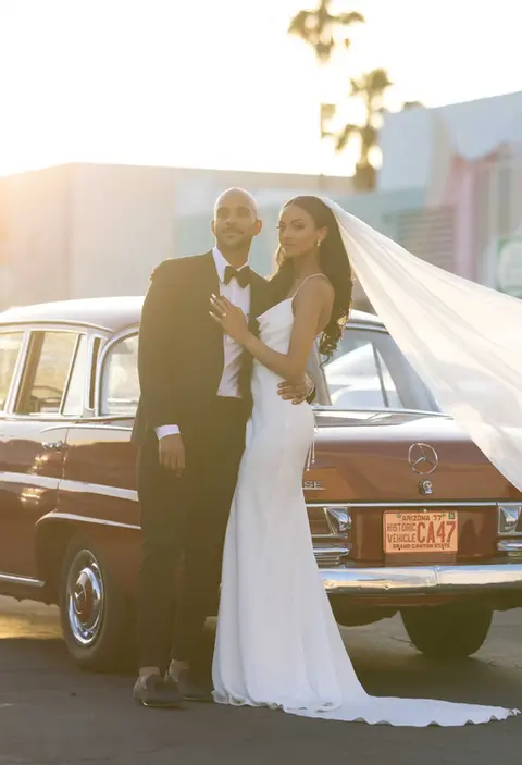 Bride & groom standing for portrait in front of Tucson resort.