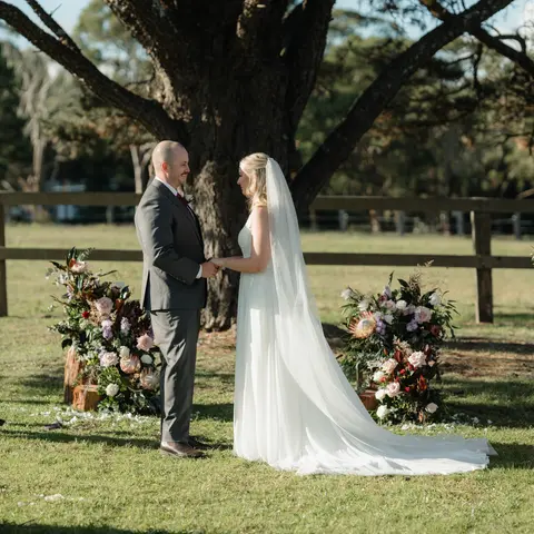 Romantic wedding ceremony flowers at The Stables of Somersby designed by Kurtzy’s wedding florist