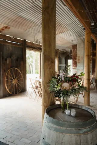 Romantic wedding reception flowers at The Stables of Somersby designed by Kurtzy’s wedding florist