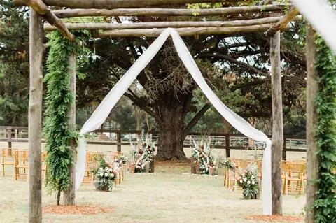 Romantic wedding ceremony flowers at The Stables of Somersby designed by Kurtzy’s wedding florist