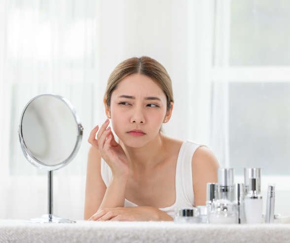 Woman checking on mirror her skin concern