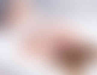 Bride wearing sheets during boudoir session