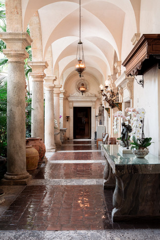Stone arcade with terracotta floors and classical sculptures at Vizcaya – perfect for stylish, European-inspired wedding photography