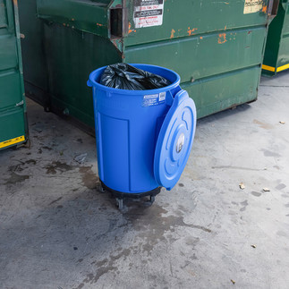 Magnum Pro-Series 44 Gallon Trash Can in Blue with the lid off and full of trash
