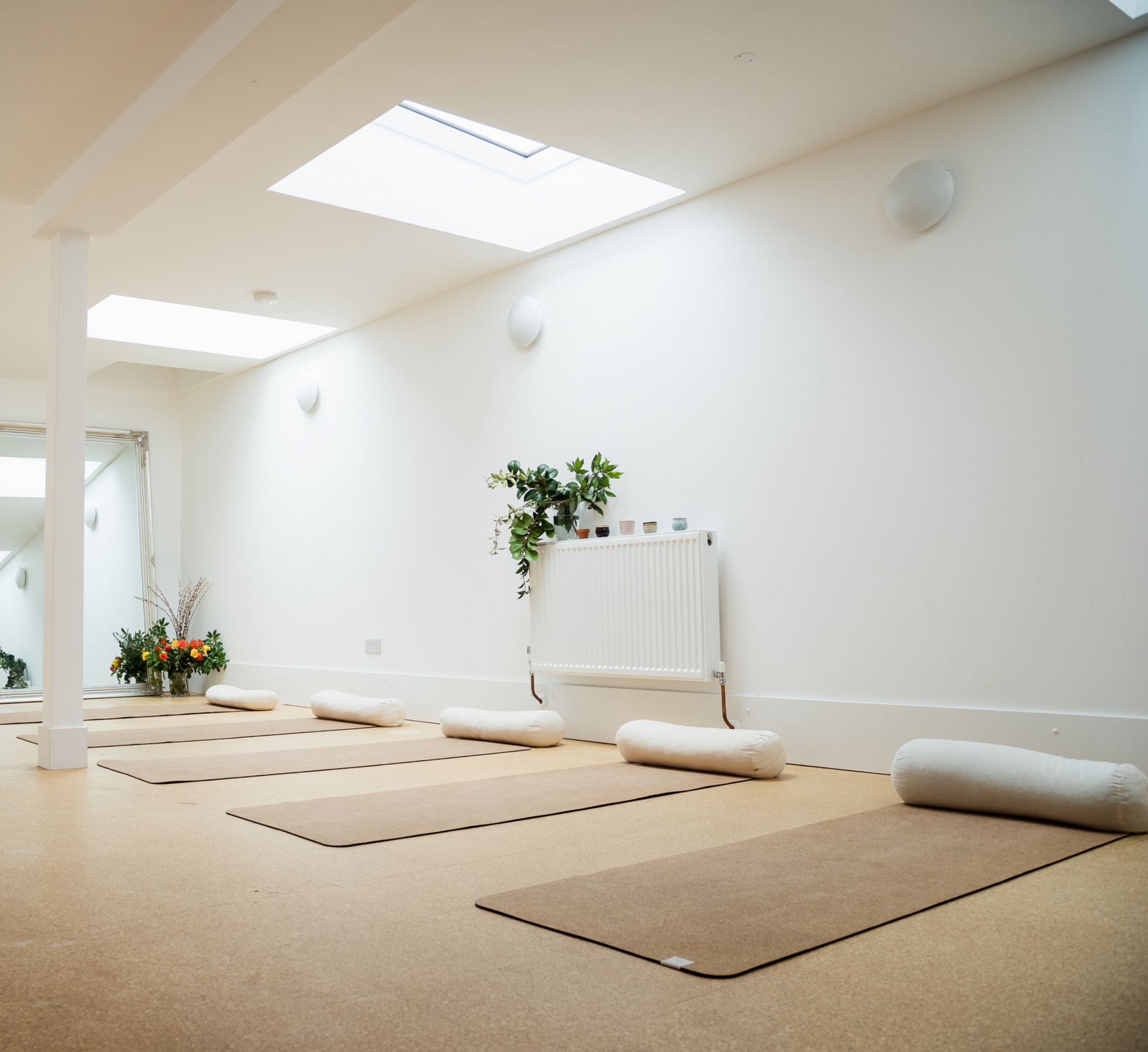 A yoga studio with mats on the floor.