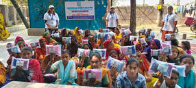 Group of women holding items; banner reads 