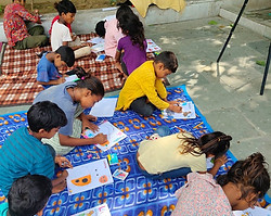 group of underprivileged kids using coloring books