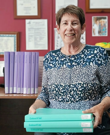 Maureen with folders of testimonials and newspaer articles