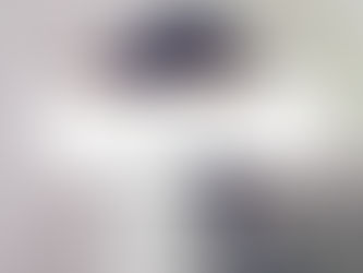 bearded man leaning on his forearm with his head down