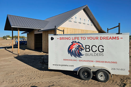 custom horse barn behind BCG Builders trailer