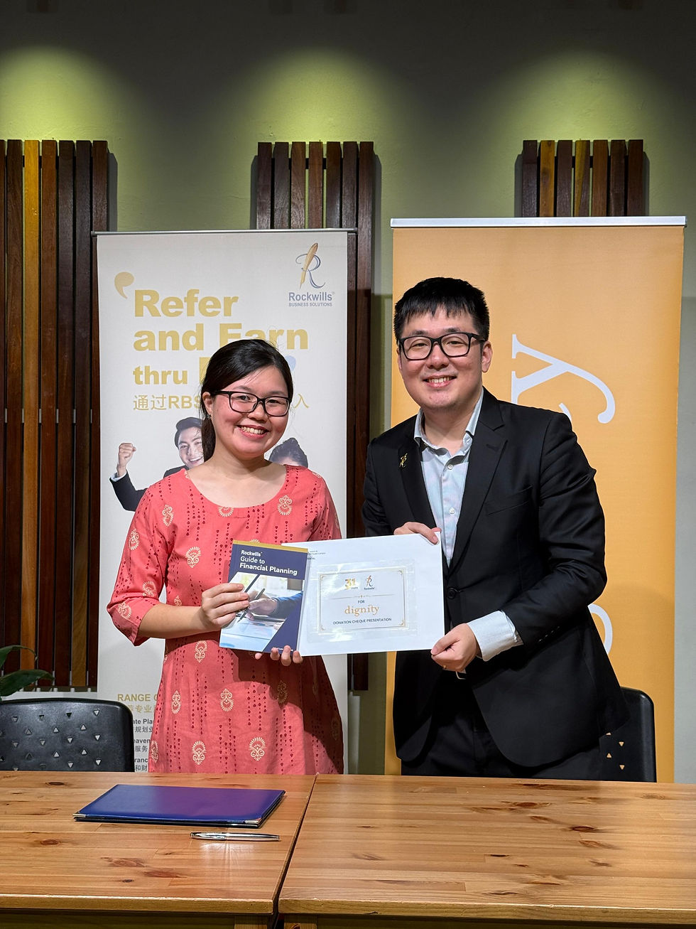 Renee Koo (邱慧旖), Head of Marketing & Communications, Dignity for Children Foundation (left), and Jason Tham Jiessen (谭杰昇), Senior General Manager, Rockwills (right), exchange partnership collaboration documents following the signing ceremony.