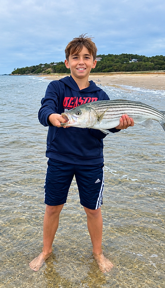 Proud Young Angler with Striped Bass.png