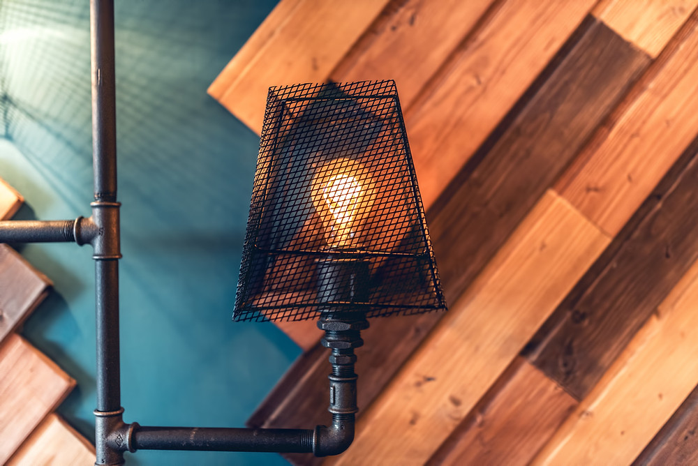 Reclaimed wood wall with pipe lighting