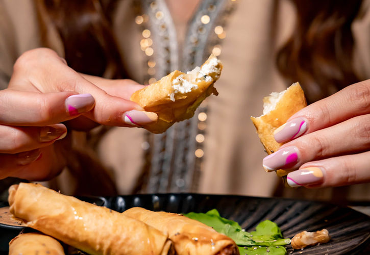 Lady eating Cheese Sujok at Bushra Abu Dhabi