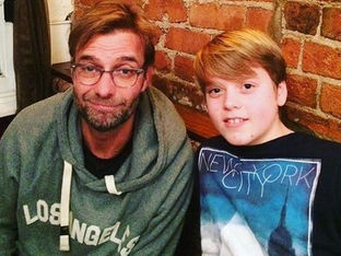 Jurgen Klopp poses for a photo at a Formby pub with young fan