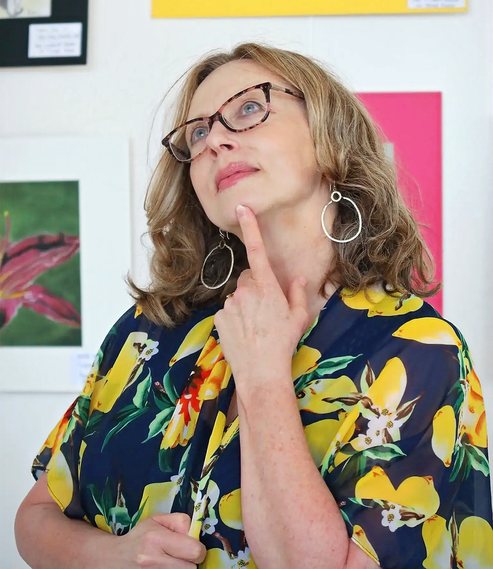 Artist in lemon print dress pensive in the studio