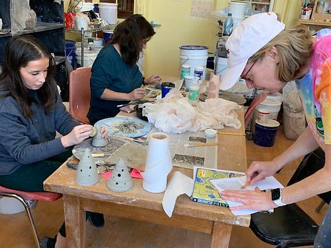 An adult group participating in a clay experience