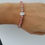 Miniature : Bracelet rhodocrosite 6mm + fleur de lotus
