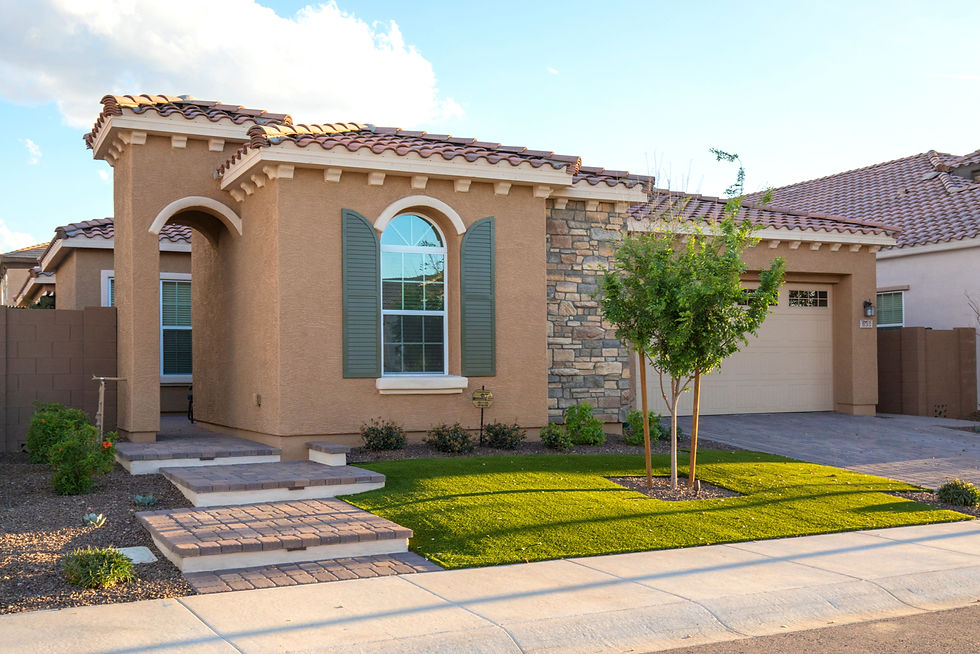 Custom front yard in Gilbert with lighted paver steps, artificial turf, paver driveway