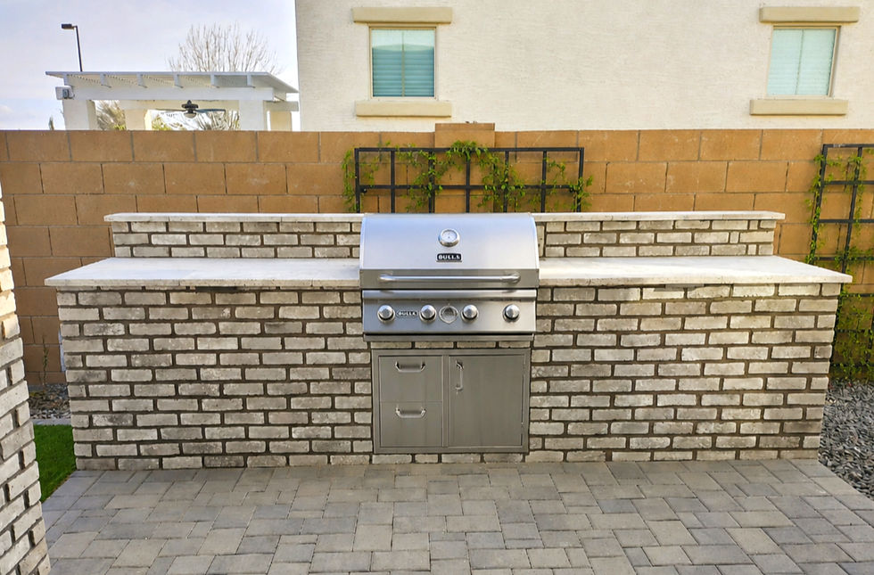 Outdoor built-in bbq unit with white washed brick and two service drawers