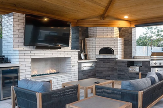 outdoor covered patio with firepit, pizza oven, outdoor tv and outdoor kitchen.