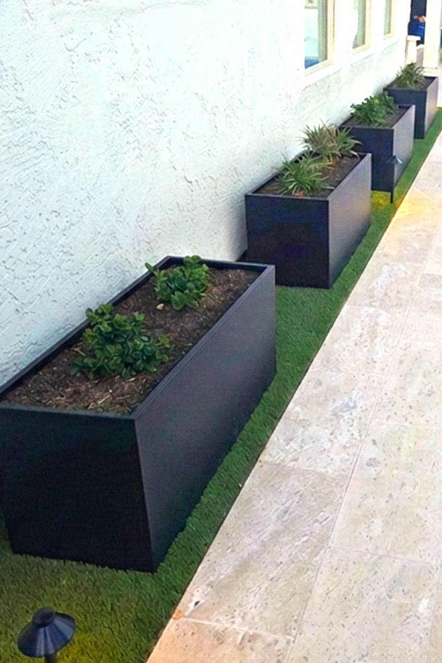 Modern raised planters with desert plants adding height to a flat Arizona backyard