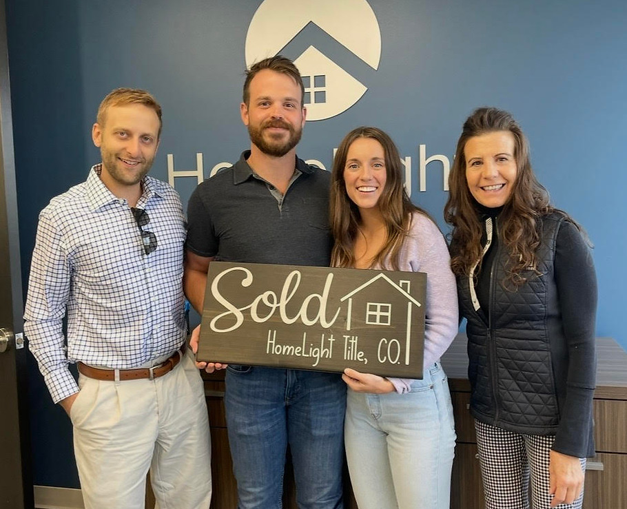 Community West Mortgage team celebrating a successful home closing with new homeowners.