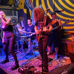 female lead singer with two guitar players and the drummer